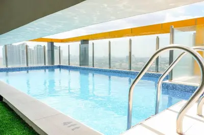 a swimming pool on the floor of a building at Cozy Spacious Hotel Type Condo with PS5 Smart TV and WiFi in Manila