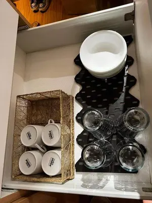 a group of cups and plates in a drawer at Azure Urban Resort Staycation by LV in Manila