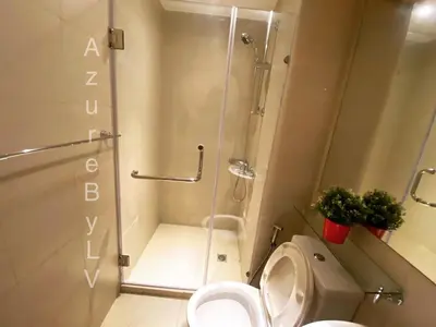 a bathroom with a shower stall and a toilet at Azure Urban Resort Staycation by LV in Manila