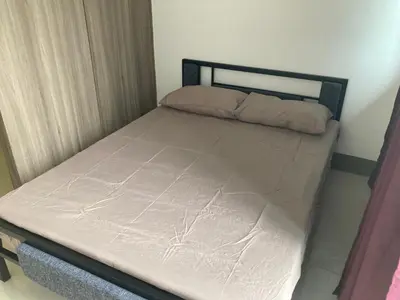 a bed in a small room with at Penthouse studio at Fame Residence 41st Floor, ShangriLa-Megamall in Manila