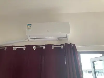 a air conditioner is on the wall above a curtain at Penthouse studio at Fame Residence 41st Floor, ShangriLa-Megamall in Manila