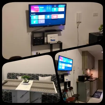 a view of a living room with a television on a wall at Penthouse studio at Fame Residence 41st Floor, ShangriLa-Megamall in Manila