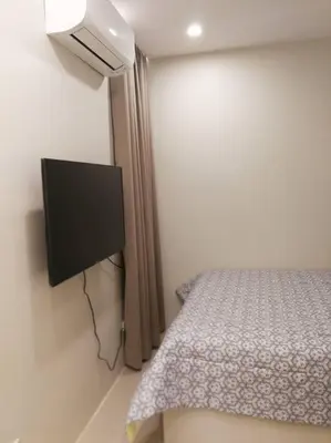 a bedroom with a bed and a flat screen tv at Adria Residences - Emerald Garden - 2 Bedroom Unit for 4 person in Manila