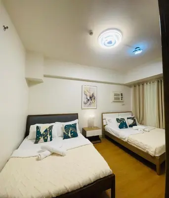 a bedroom with two beds in a room at 1 Bedroom Condo near US Embassy and St Lukes Medical Clinic in Manila