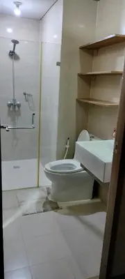 a bathroom with a toilet and a sink at RQUI CONDOTEL in NAIA TERMINAL 3 at Two Palmtree Villas in Manila