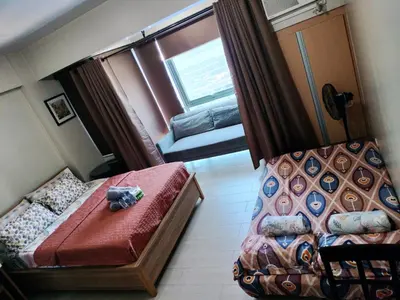 a small room with a bed and a window at Room Across Naia Terminal 3 by Rqui in Manila