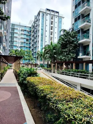 a walkway in a city with tall buildings at Room Across Naia Terminal 3 by Rqui in Manila