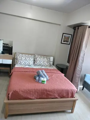 a bedroom with a bed with two stuffed animals on it at Room Across Naia Terminal 3 by Rqui in Manila