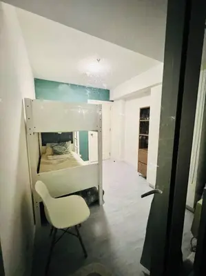 a room with a bed and a chair in it at Azure 2bedroom Condo With Balcony in Manila