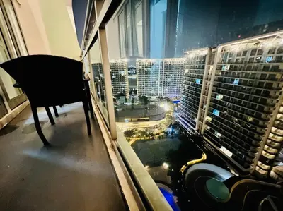 a room with a window with a view of a city at Azure 2bedroom Condo With Balcony in Manila