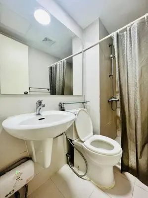 a bathroom with a toilet and a sink at Azure 2bedroom Condo With Balcony in Manila