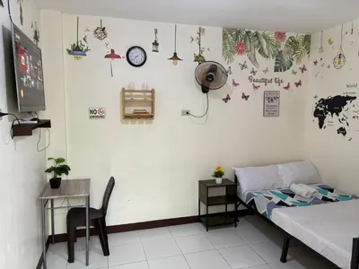 a room with a bed and a table and a desk at AIRPORT VILLAMOR TRANSIENT ROOMS in Manila