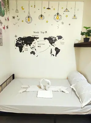 a room with a bed with a map of the world at AIRPORT VILLAMOR TRANSIENT ROOMS in Manila