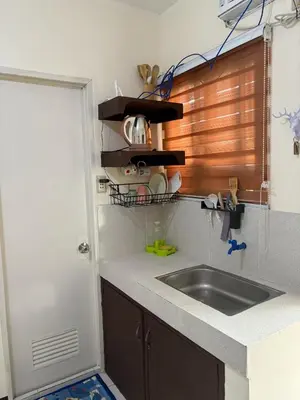a kitchen with a sink and a counter top at AIRPORT VILLAMOR TRANSIENT ROOMS in Manila