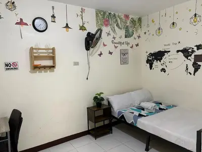a room with a bed and a map of the world on the wall at AIRPORT VILLAMOR TRANSIENT ROOMS in Manila
