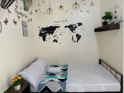 a bedroom with a map of the world on the wall at AIRPORT VILLAMOR TRANSIENT ROOMS in Manila