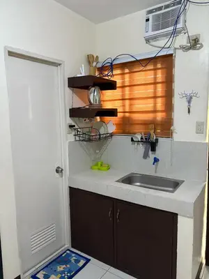 a kitchen with a sink and a counter top at AIRPORT VILLAMOR TRANSIENT ROOMS in Manila