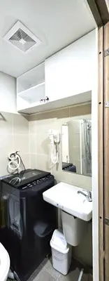 a bathroom with a sink and a toilet and a mirror at Coast Residences - 2 Bedroom with Balcony facing Mall of Asia, Manila Bay & Pool View in Manila
