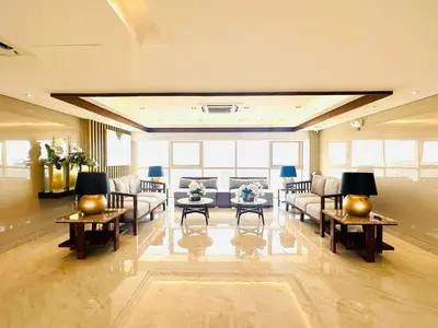 a large living room with couches and tables at Coast Residences - 2 Bedroom with Balcony facing Mall of Asia, Manila Bay & Pool View in Manila