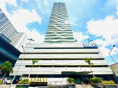 a tall white building with a samsung sign on it at Coast Residences - 2 Bedroom with Balcony facing Mall of Asia, Manila Bay & Pool View in Manila