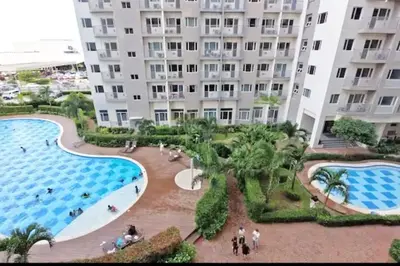 a view of a large apartment building with two pools at Chic 2BR Condo Unit at South Residences in Manila