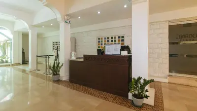 a lobby with a cash register in a building at Garden Plaza Hotel Manila in Manila