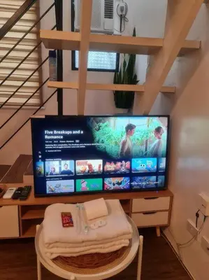 a computer monitor sitting on a table with a chair at Muji-Inspired, Studio-Type Home at Phirst Park Homes Tanza in Tanza