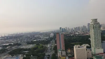 an aerial view of a city with a tall building at MANILA BAY EXECUTIVE SUITE pearl of orient in Manila