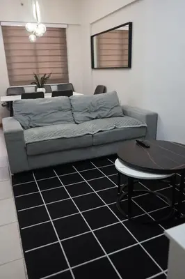 a living room with a couch and a table at Alea Residences in Manila