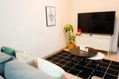 a living room with a couch and a table at Alea Residences in Manila