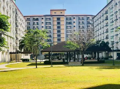 a gazebo in a park in front of a large building at Field Residence SMDC 1BR w/ Netflix in Manila