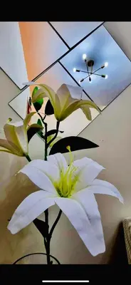 a white flower in a vase with an umbrella at Field Residence SMDC 1BR w/ Netflix in Manila
