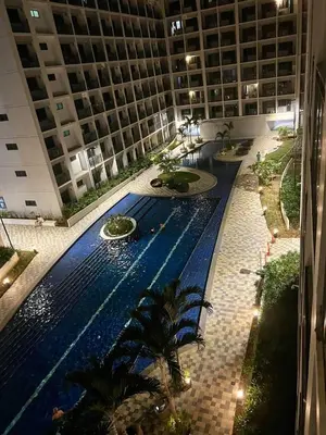 a large building with a swimming pool in front of a building at M&M Condostay at Shore 2 Residences Tower 2 Pasay City in Manila