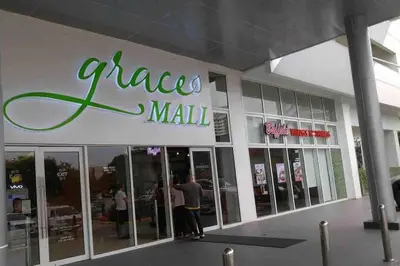 a man standing in front of a pizza mall at TriG Place at Grace Residence in Taguig City in Manila
