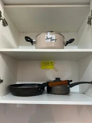 a pot and a pan on a shelf in a kitchen at TriG Place at Grace Residence in Taguig City in Manila