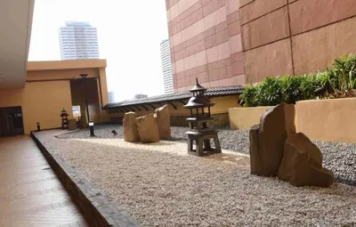 a courtyard with a lantern in a building at Cozy Condo near US EmbassyErmita Manila/ Roxas blvd/ Dolomite beach in Manila