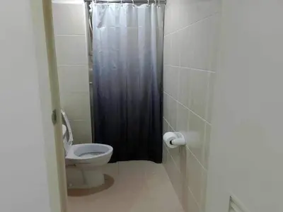 a bathroom with a toilet and a shower stall at Cozy Condo near US EmbassyErmita Manila/ Roxas blvd/ Dolomite beach in Manila