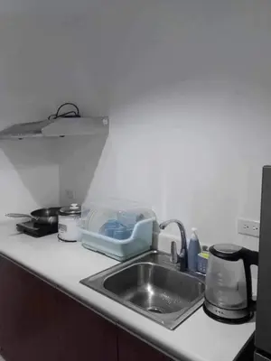 a kitchen counter top with a sink and a counter top at Cozy Condo near US EmbassyErmita Manila/ Roxas blvd/ Dolomite beach in Manila