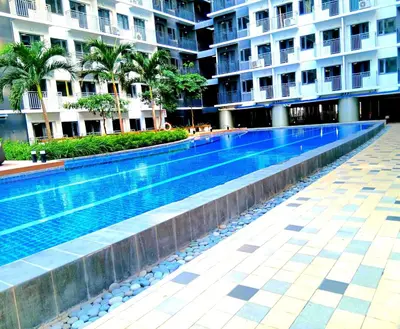 a swimming pool in the middle of a building at A&R Condo by the Bay in Manila