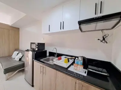 a kitchen with a sink and a counter top at Elresa Elegant at Field Residences Condominium Hotel in Manila