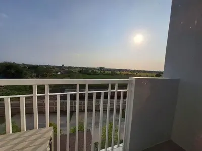 a balcony with a view of the ocean and the sun at Elresa Elegant at Field Residences Condominium Hotel in Manila