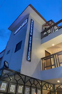 a building with a sign on the side of it at Aurora Suites Pasay near Airport in Manila