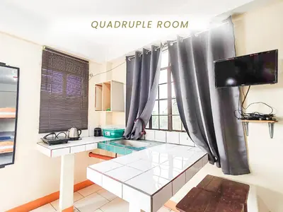 a living room with a table and a tv in a room at Cenco Suites Residences - Transient in Tanza Cavite in Tanza