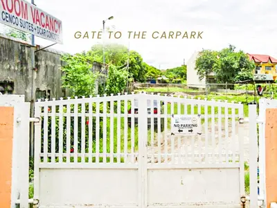a white fence with a gate to the car park at Cenco Suites Residences - Transient in Tanza Cavite in Tanza