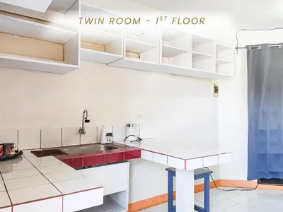 a kitchen with white cabinets and a red sink at Cenco Suites Residences - Transient in Tanza Cavite in Tanza