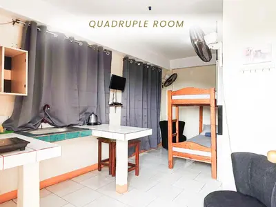 a small kitchen with a table and a bunk bed at Cenco Suites Residences - Transient in Tanza Cavite in Tanza
