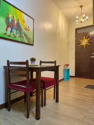 a dining room with a table and two chairs at Rafaella Sunset - Deluxe Room in Manila