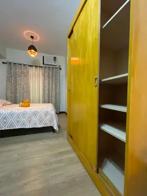 a room with a bed and a book shelf at Rafaella Sunset - Deluxe Room in Manila
