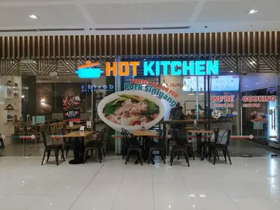 a restaurant with tables and chairs and a hot kitchen sign at Love@Grace Residences near BGC. in Manila