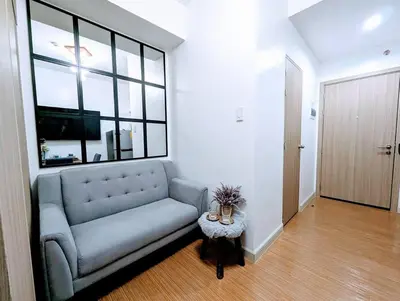 a living room with a couch and a table at Love@Grace Residences near BGC. in Manila
